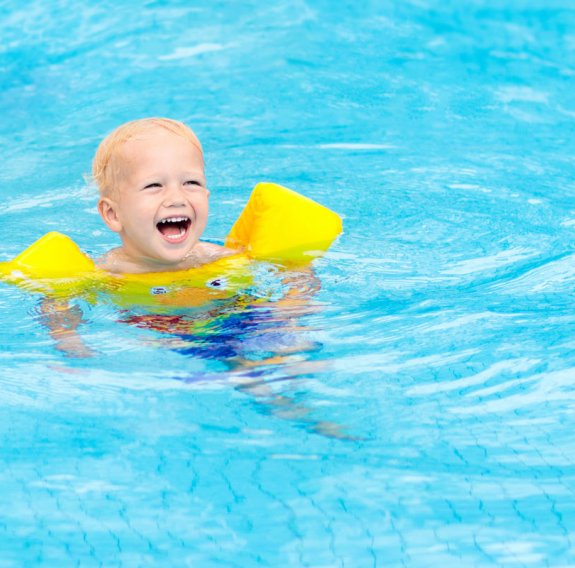 Kind schwimmt im Wasser