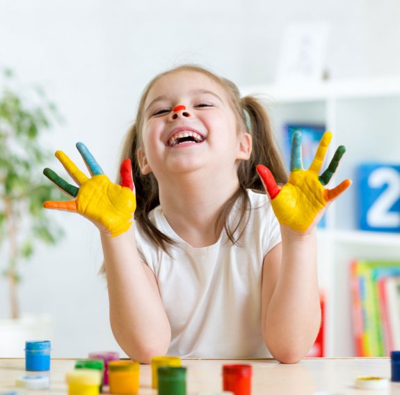 Kind zeigt ihre bemalten Hände