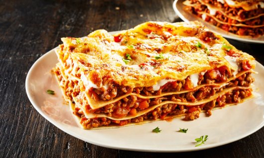 Ein Stück Lasagne auf einem Teller