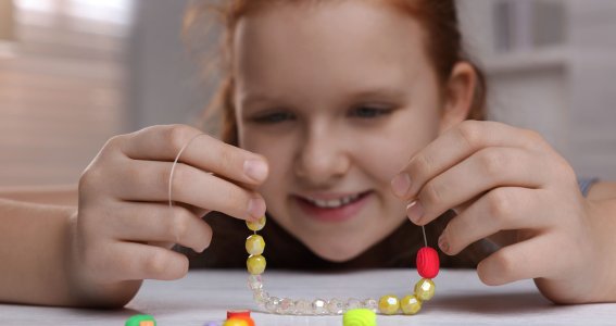 Mädchen gestaltet ein Armband