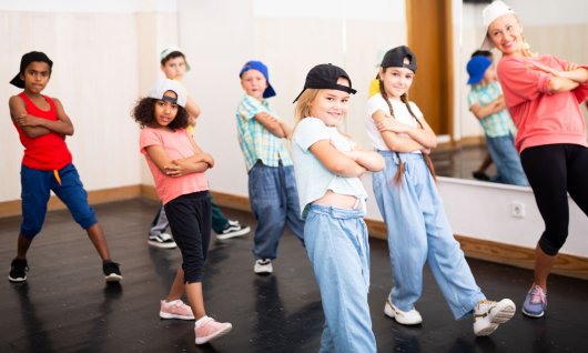 Eine Gruppe von Kindern in lässiger Kleidung posiert in Hip Hop Tanzpose