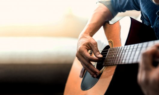Person spielt auf der Gitarre