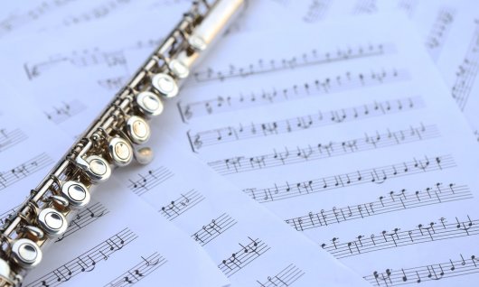 Querflöte liegt auf vielen Notenblättern