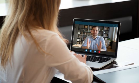 Frau sitzt vor Laptop