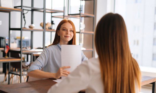 Frau hält ein Stapel Papier 