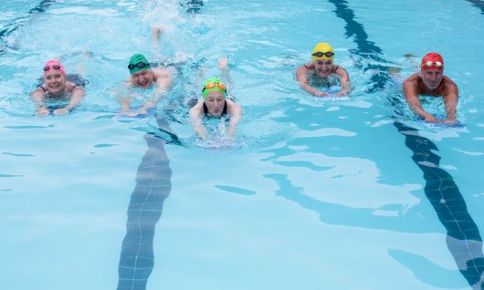 Erwachsene lernen schwimmen mit Schwimmbrett