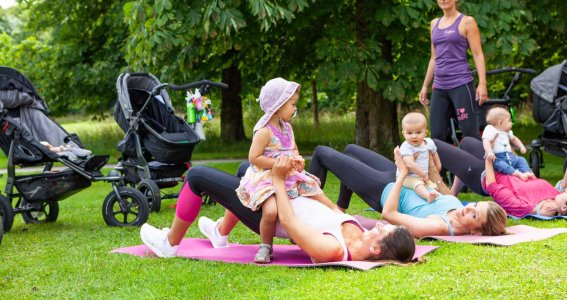 Frauen machen eine Fitnessübung mit ihrem Baby